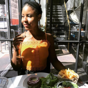 Lindiwe dining at at Byron Burgers in London, feeling compelled to say 'sorry' for her allergies.