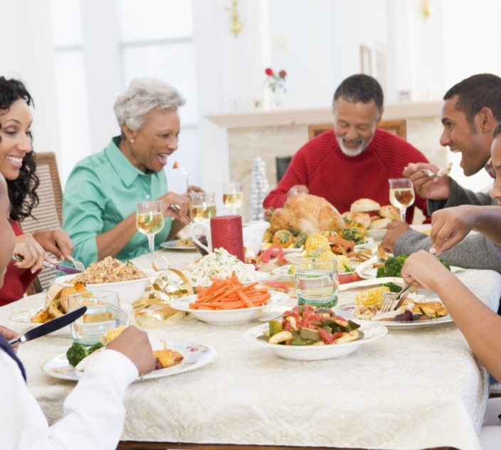 A family eating together. Visiting Relatives Safely With Food Allergies.