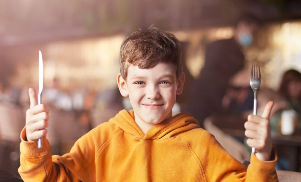 Food allergic child dining out at restaurant.