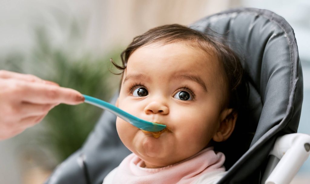 Baby being fed. Analysis Backs Early Peanut and Egg Introduction to Kids to Avoid Allergies