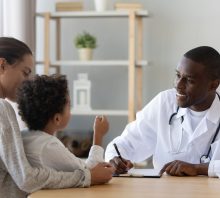 Mom, son and doctor talking about food allergy tests.