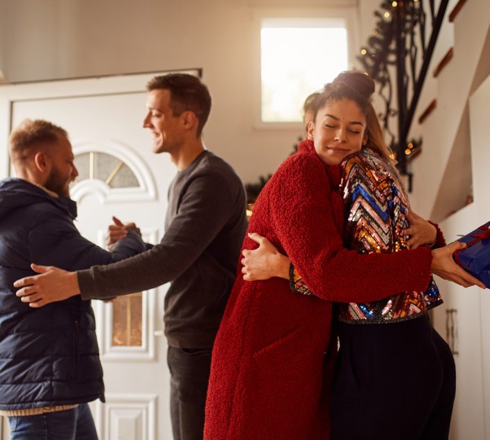 Group of friends gathering for New Year's party at home.