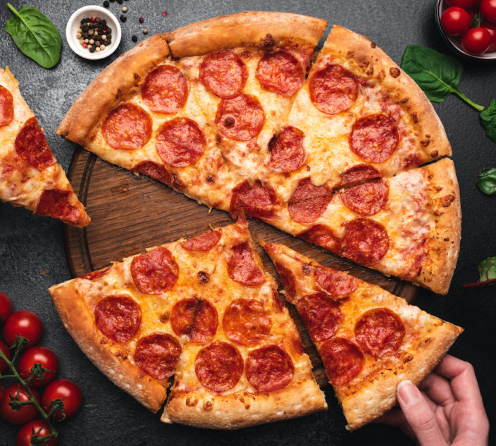 Picking slice of pepperoni pizza. Hands picking pizza slice. Top view of tasty hot pepperoni pizza on black concrete background (Picking slice of pepperoni pizza. Hands picking pizza slice. Top view of tasty hot pepperoni pizza on black background.