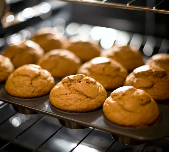Baked pumpkin muffins just coming out of the oven