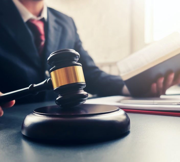 Lawyer holding the hammer and the judge read the verdict.