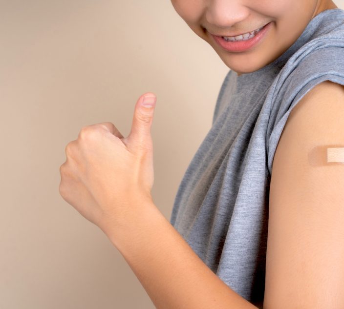 Woman with happy smile receives covid-19 vaccine.