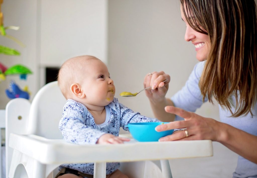 Baby being fed by his mom.