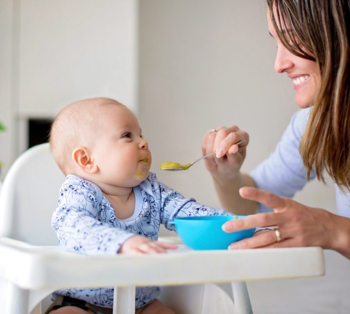 Baby being fed by his mom.