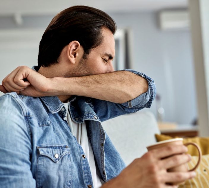 An asthma sufferer coughing.