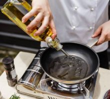 Chef cooking in a kitchen with peanut oil. Peanut oil allergy.
