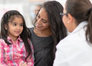 Girl with her mom and female allergist.