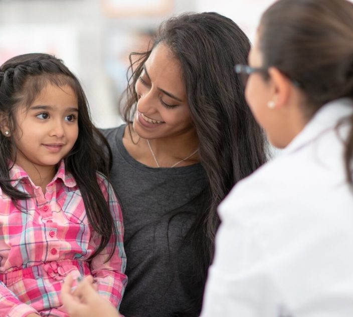 Girl, mom with allergist.