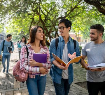 Young students at the college campus walking to class.