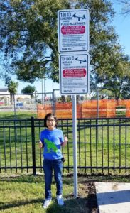 Jaythan with one of the allergy awareness park signs.